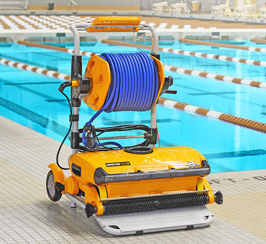 robot pool cleaner on caddy with olympic pool in the background